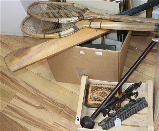 Two tennis racquets, a box, a horse door stop, a Zulu knobkerrie and a cricket bat